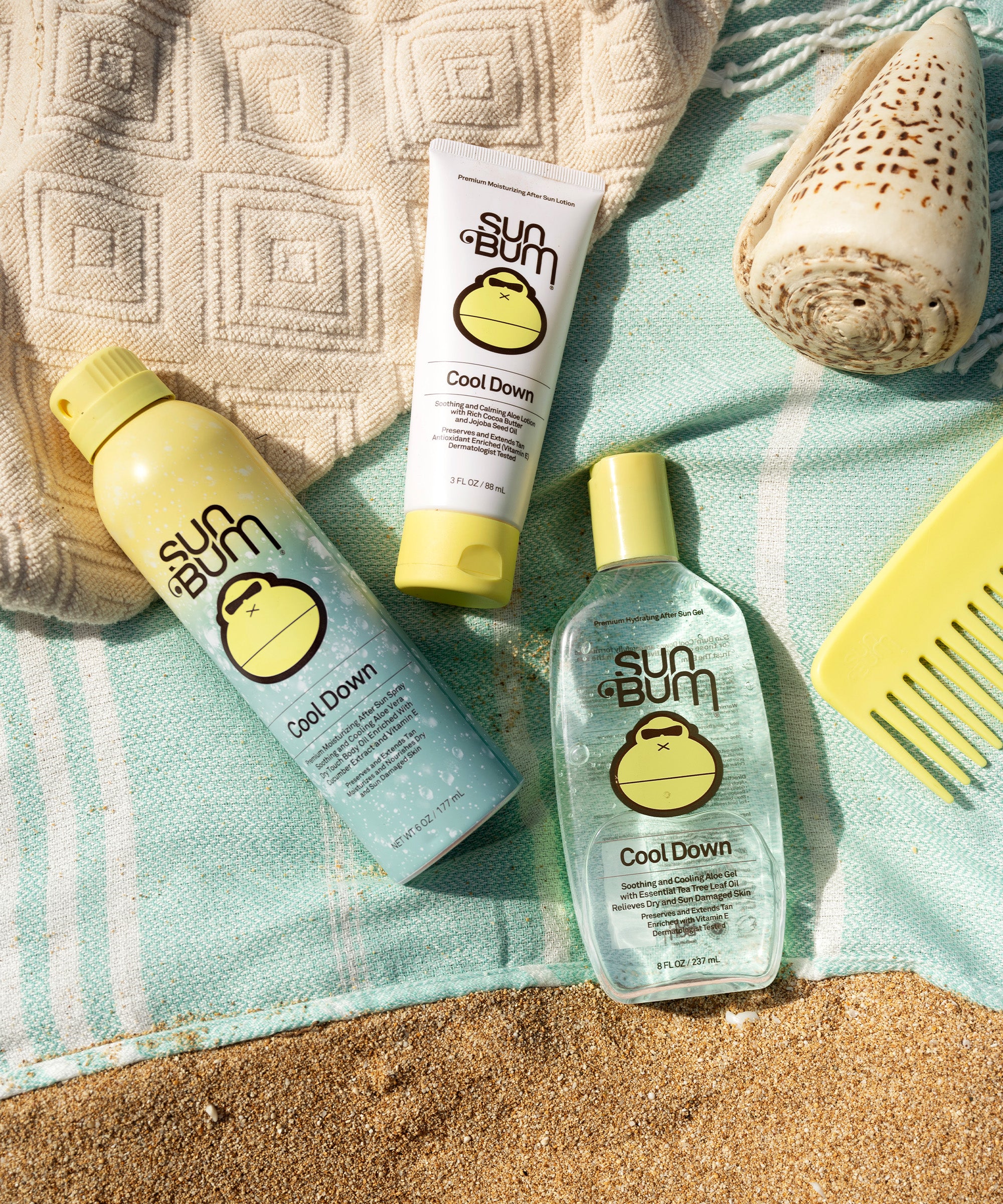 Sun Bum After Sun Cool Down Lotions on a beach towel with seashells and a straw hat, perfect for soothing sunburns with aloe, Sun Bum
