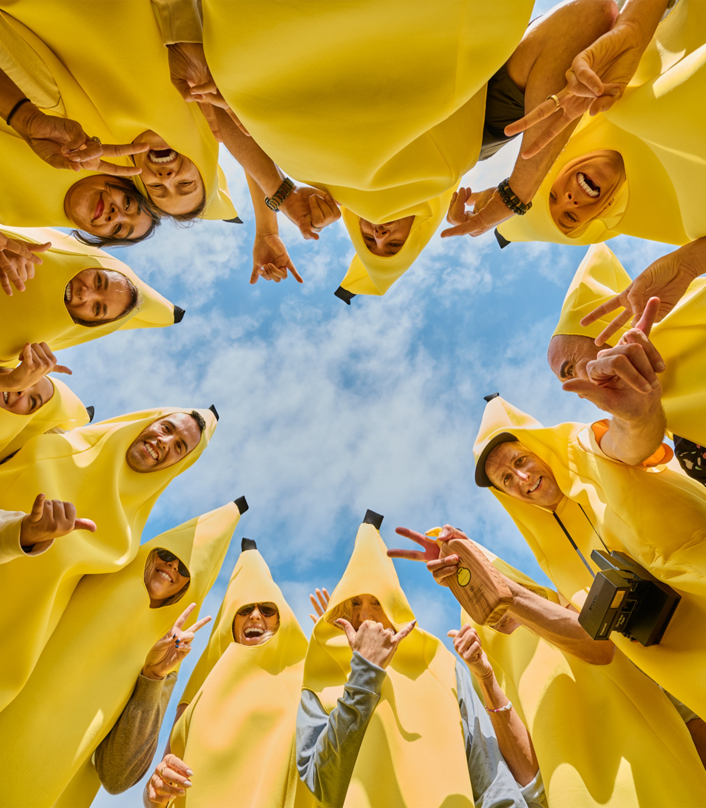 People wearing banana suits against a blue sky - original sunscreen
