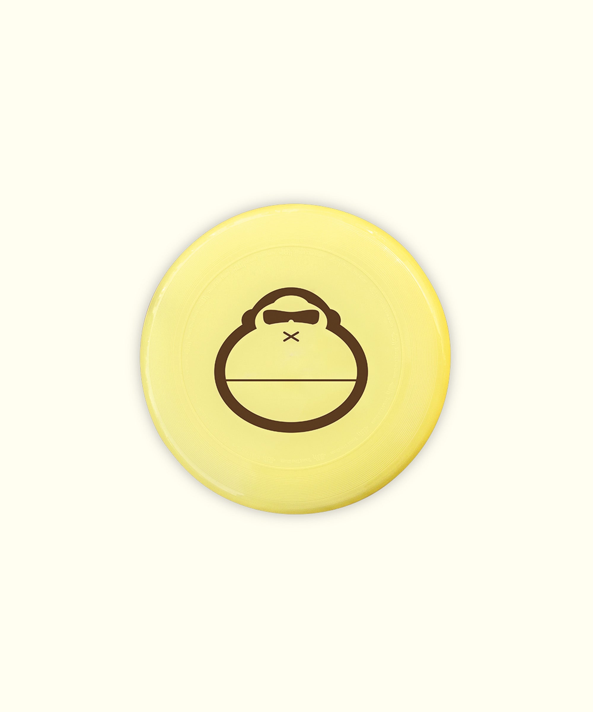 A yellow flying disc with a cartoon character illustration in the center.