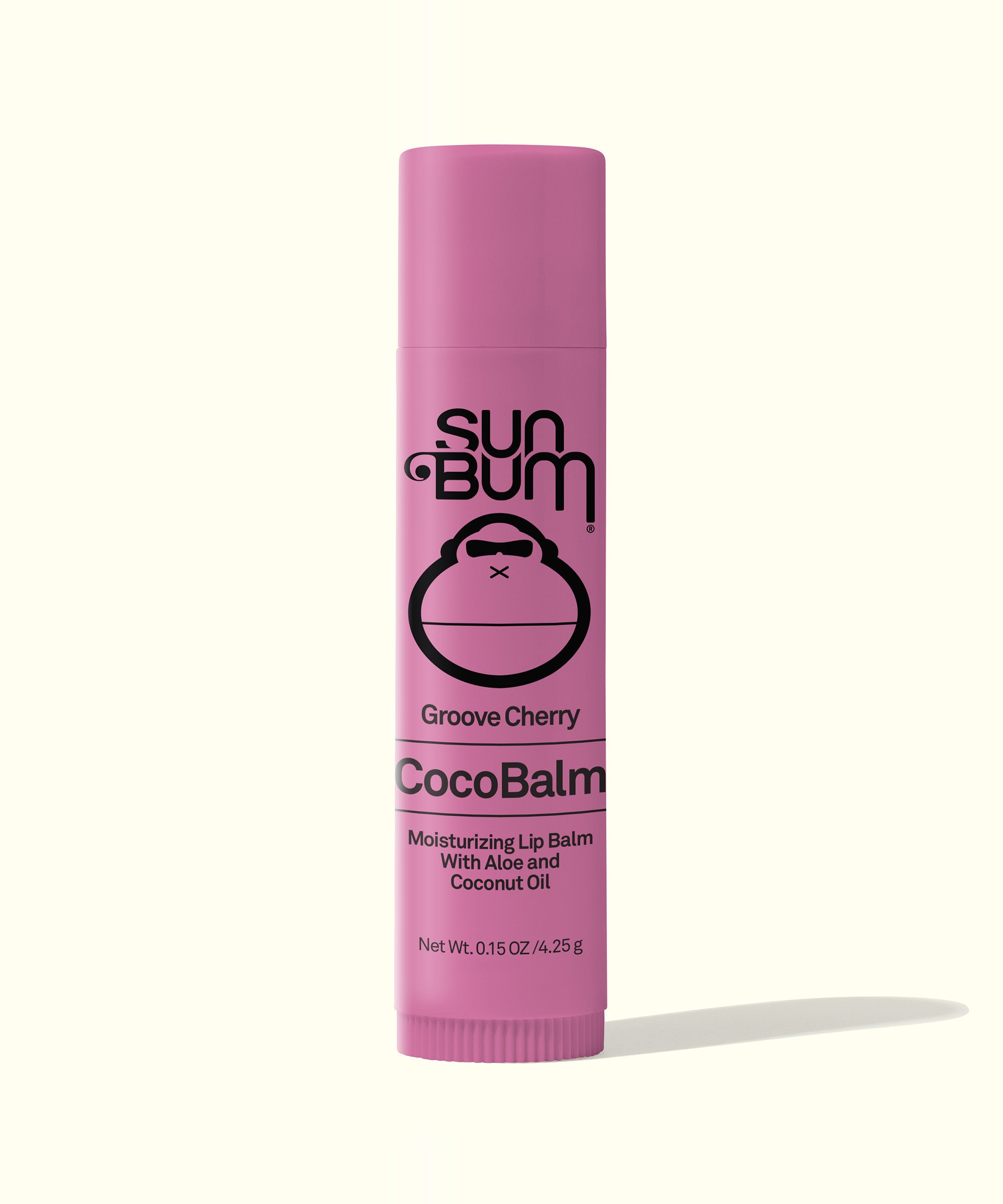 A pink tube of Sun Bum CocoBalm lip balm with the flavor 'Groove Cherry' indicated on the packaging.