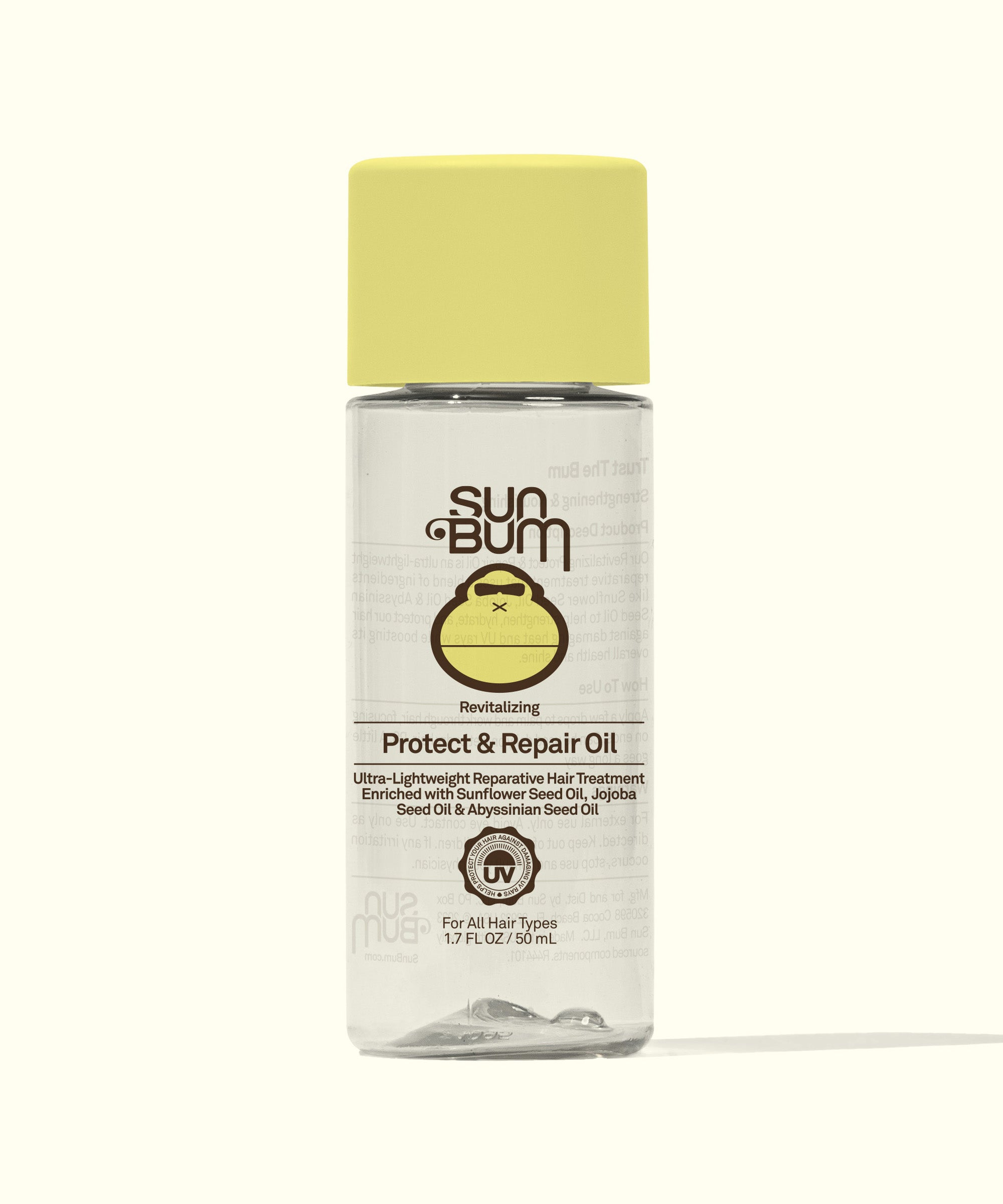 A bottle of Sun Bum Protect & Repair Oil with a yellow cap, labeled with the brand logo and product information.