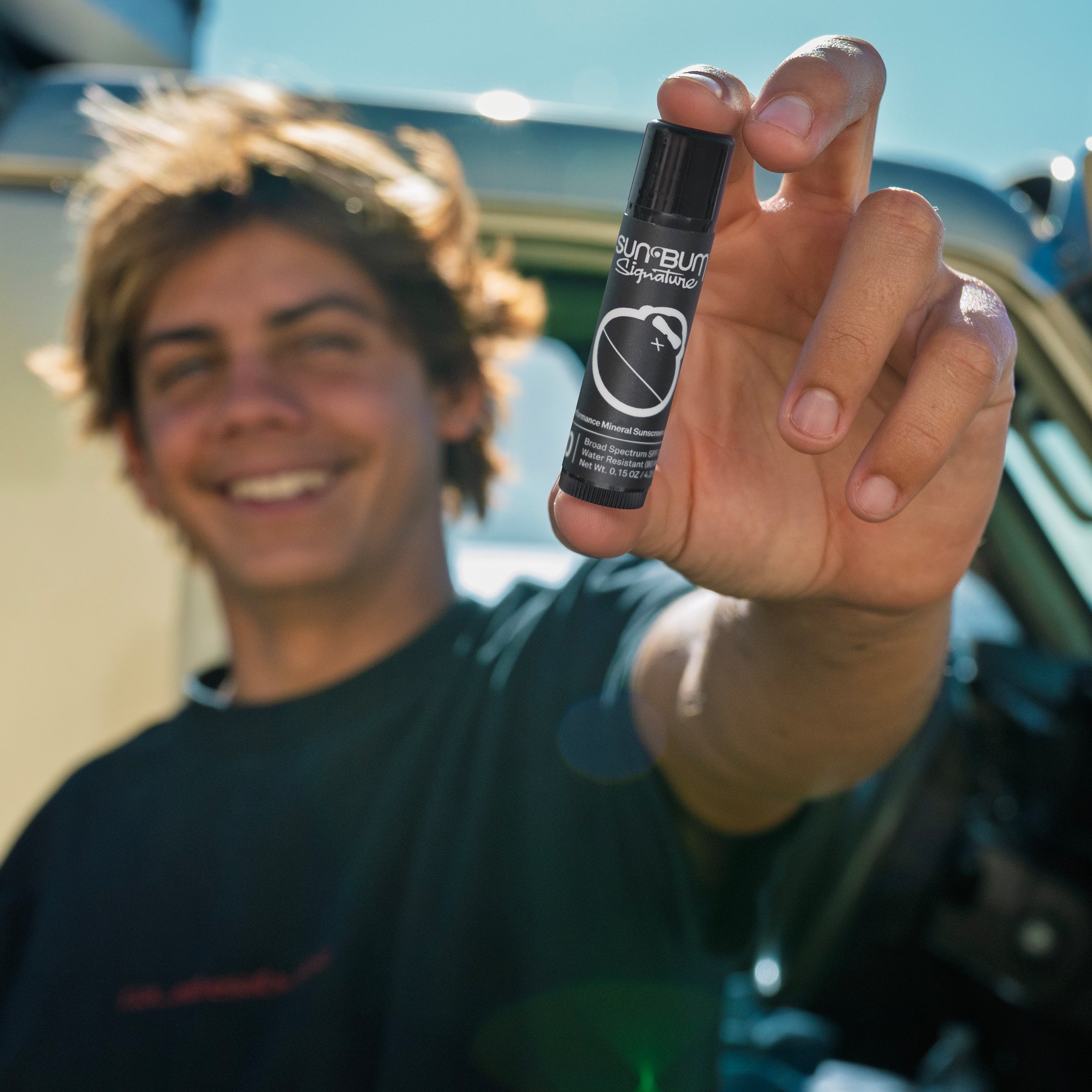 Person holding a Sun Bum Signature lip balm