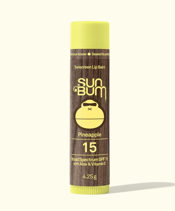 Sun Bum Sunscreen Lip Balm tube with pineapple flavor on a white background