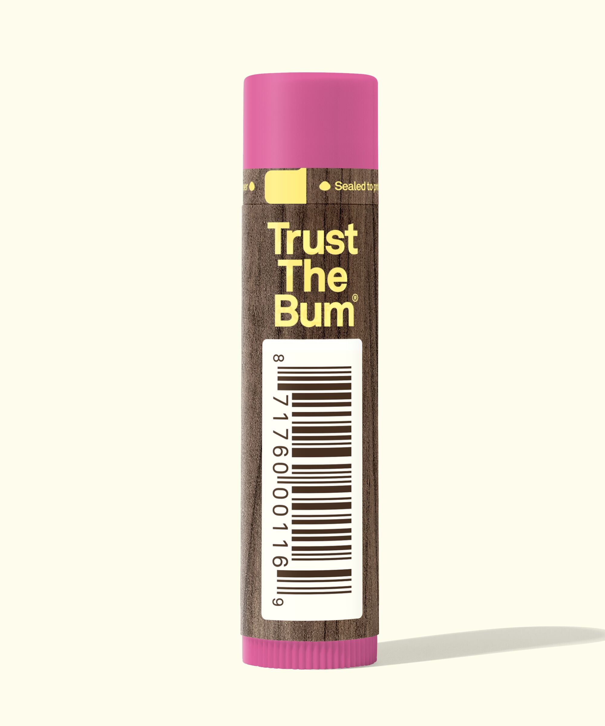 Balm with pink cap and brown body displaying 'Trust The Bum' text on a white background