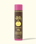 Sun Bum suncreen lip balm with pink cap and brown body on a white background