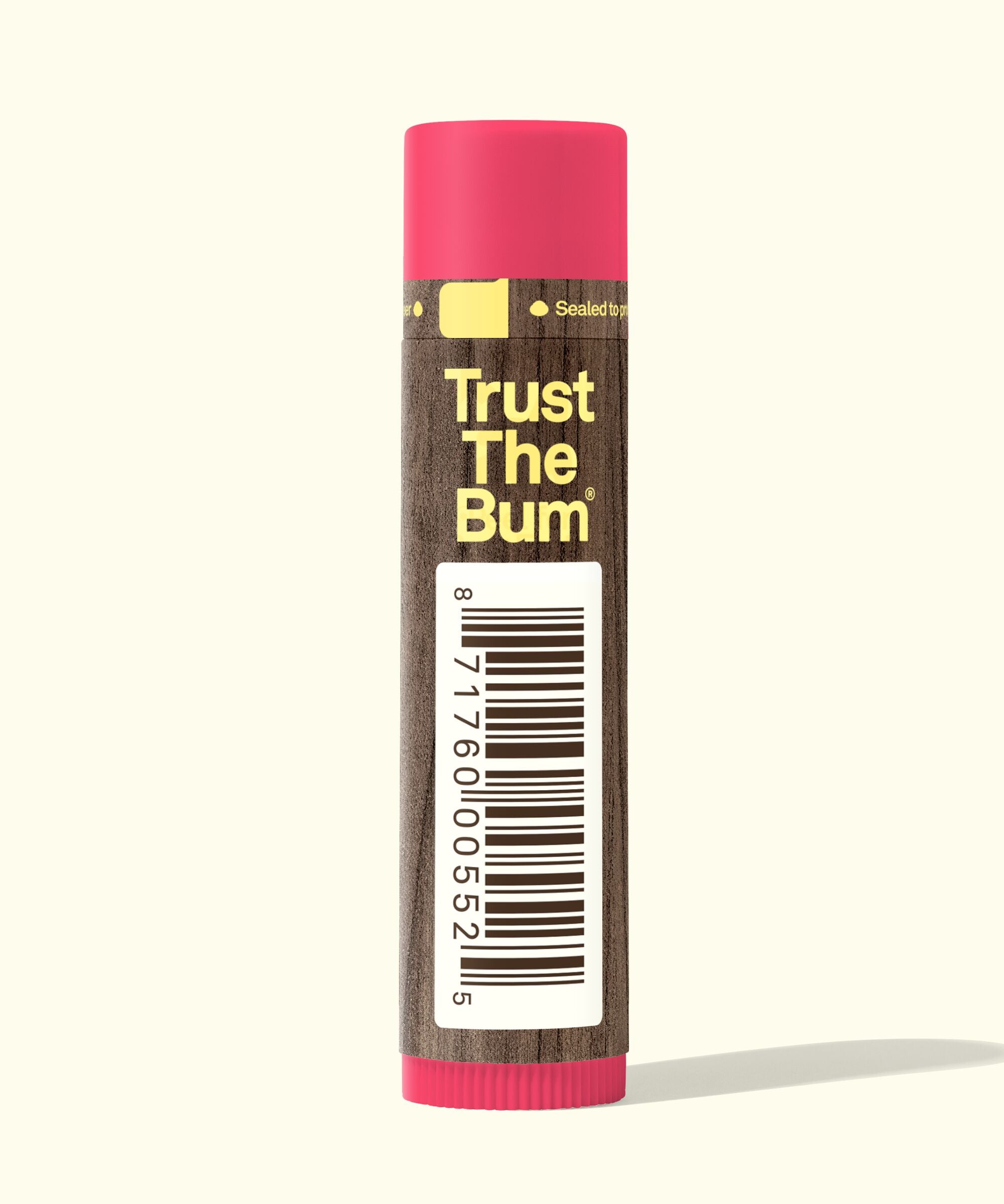 Lip balm with pink cap and brown label on a white background