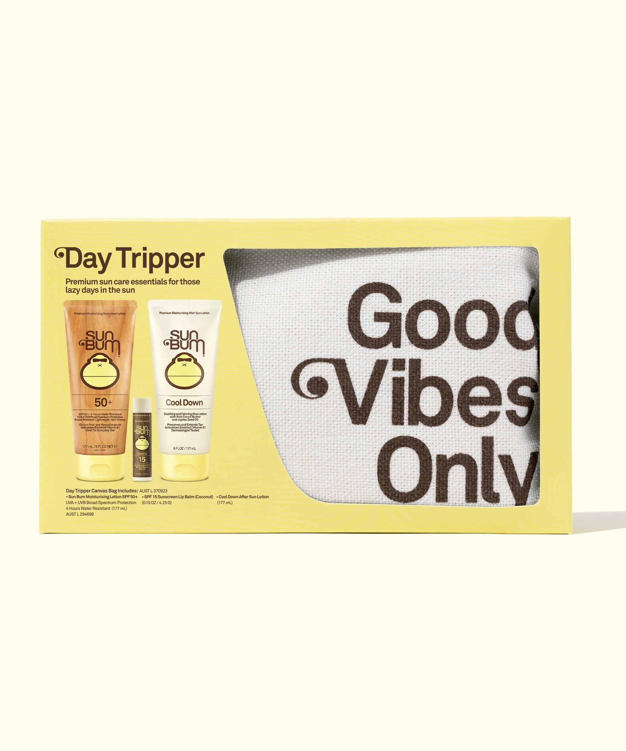 A packaged travel-sized sun care set labeled 'Day Tripper' by Sun Bum, containing sunscreen, lip balm, and sunglasses, with the phrase 'Good Vibes Only' on the front.