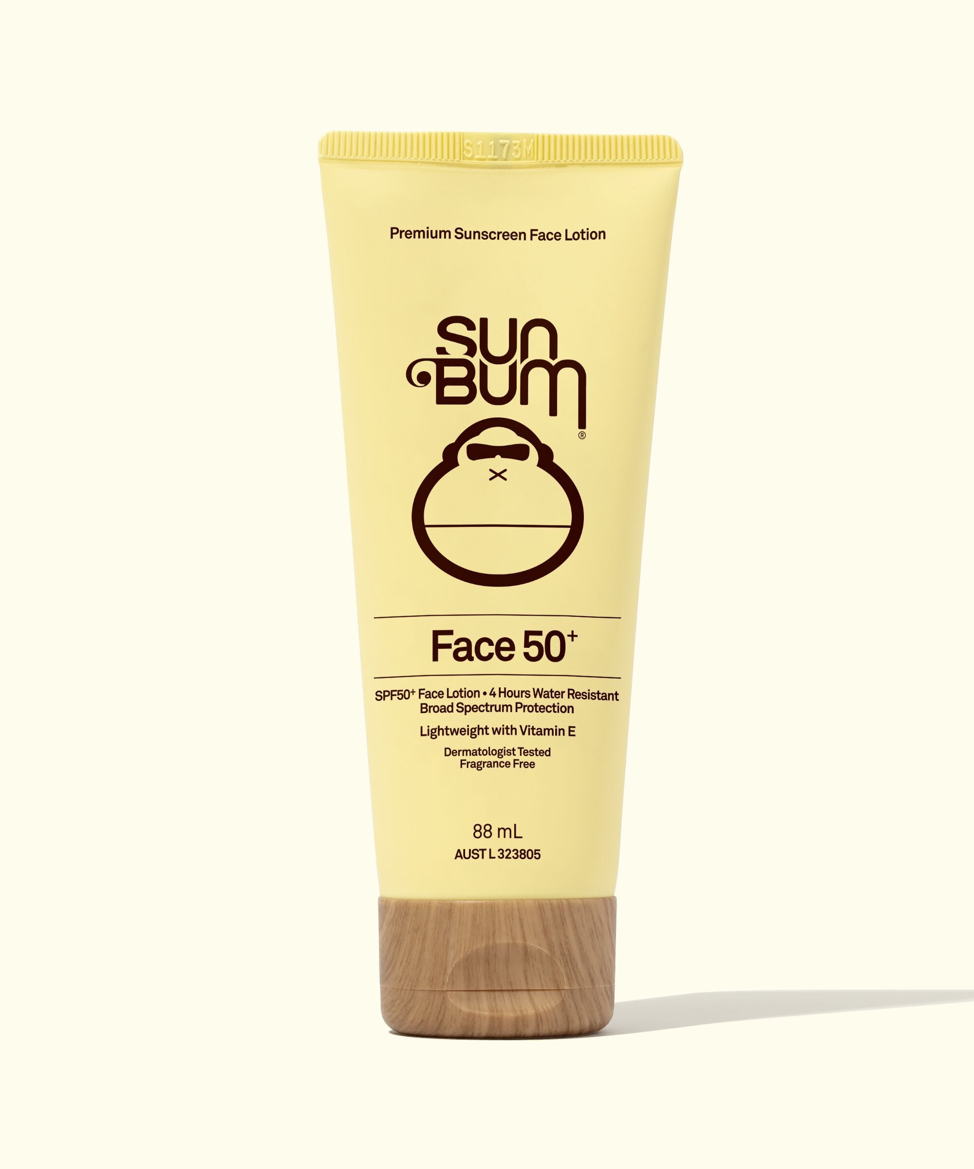 A tube of Sun Bum 'Face 50' SPF 50+ Sunscreen Lotion with a beige upper section and a wood grain lower section, indicating the product is for facial use with an SPF of 50.