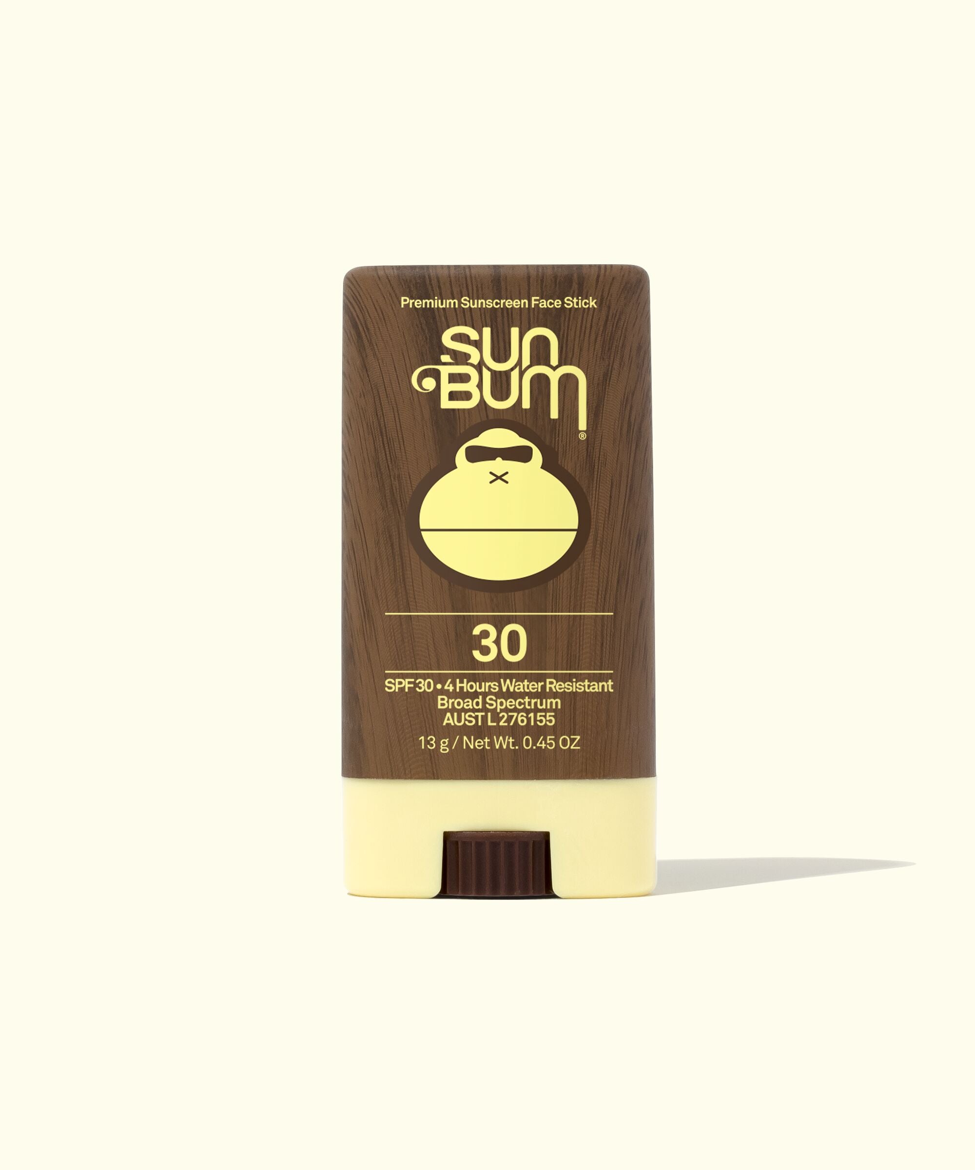 A stick of Sun Bum SPF 30 sunscreen, with a brown cap and white stick, labeled with the brand logo and product information.