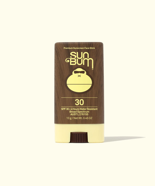 A stick of Sun Bum SPF 30 sunscreen, with a brown cap and white stick, labeled with the brand logo and product information.