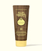 A bottle of Sun Bum Original SPF 30 Sunscreen Lotion with a brown tint and a yellow cap.