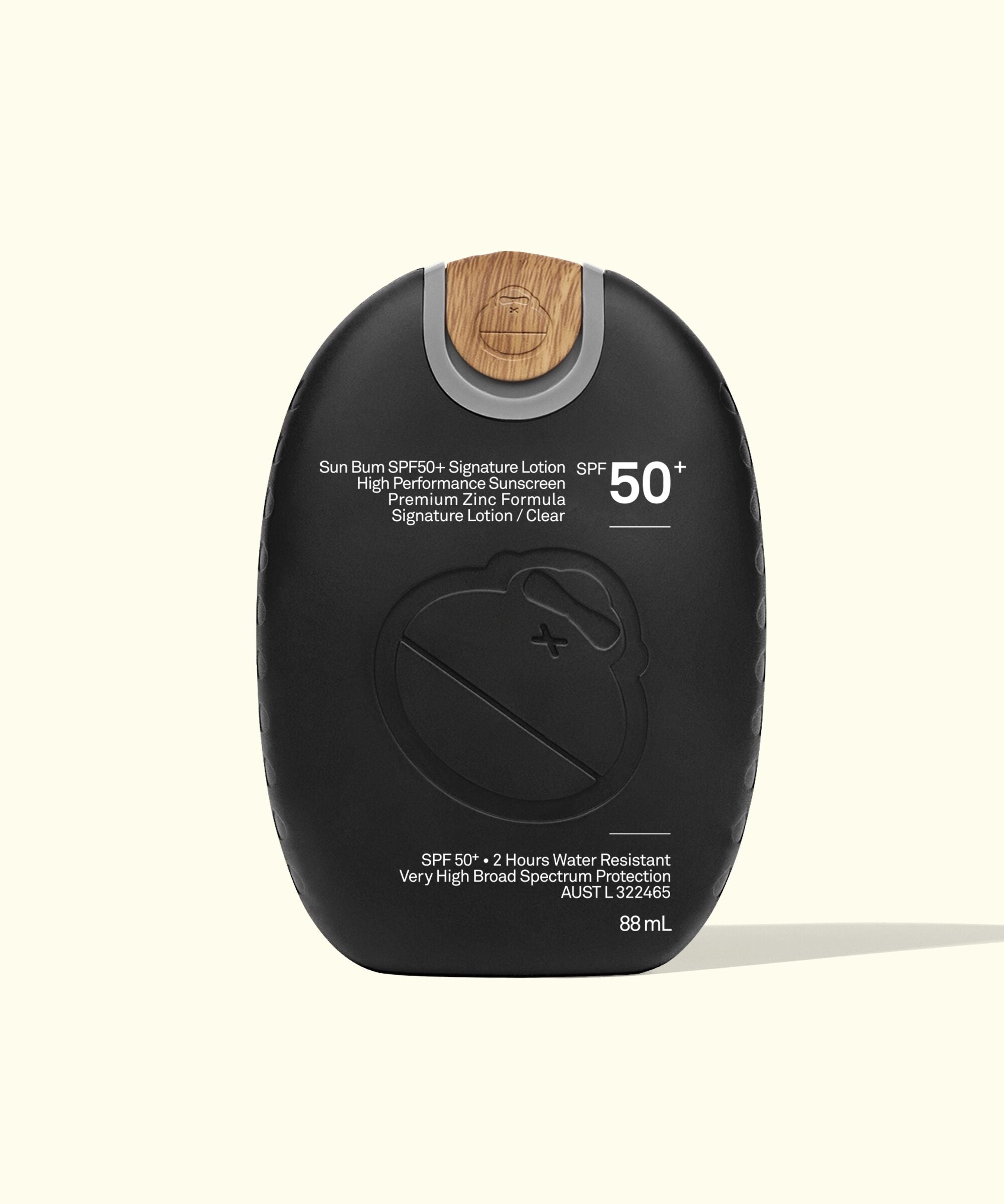A black pump bottle of Signature SPF 50+ Sunscreen Lotion with white and green text detailing the product's features.