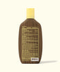Back view of the Original SPF 30 Sunscreen Lotion bottle with a brown, wood-inspired design and yellow cap, showcasing detailed ingredients and drug facts. Sun Bum