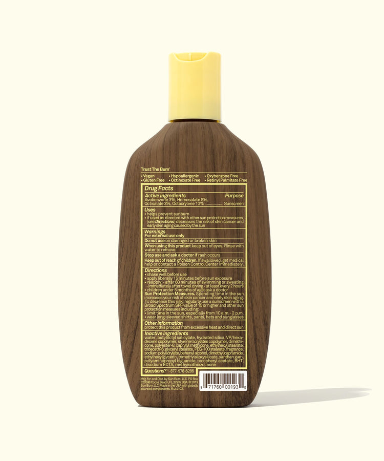 Back view of the Original SPF 30 Sunscreen Lotion bottle with a brown, wood-inspired design and yellow cap, showcasing detailed ingredients and drug facts. Sun Bum