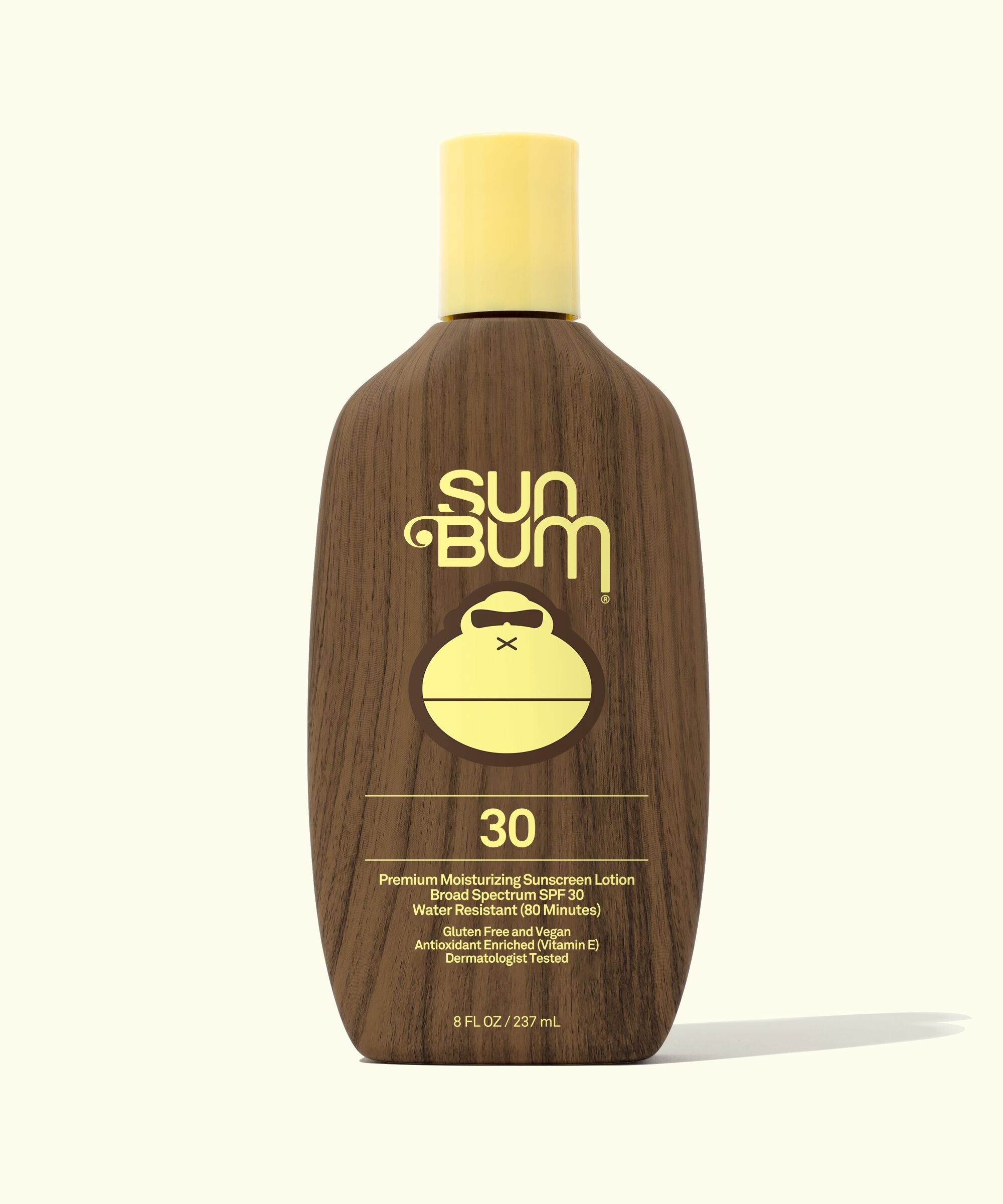 A bottle of Sun Bum Original SPF 30 Sunscreen Lotion with a brown tint and a yellow cap.