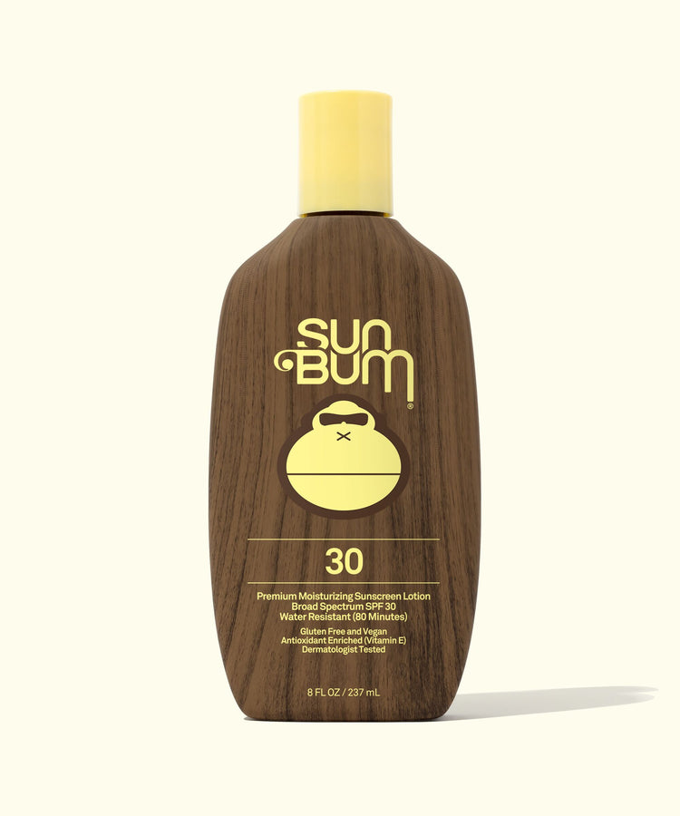 A bottle of Sun Bum Original SPF 30 Sunscreen Lotion with a brown tint and a yellow cap.