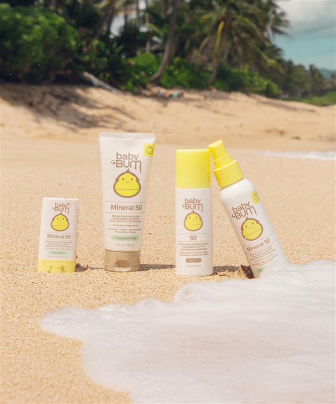 Baby Bum Mineral SPF 50 sunscreen collection on a sandy beach, safe and gentle sun care for kids - Baby Bum Collection - Sun Bum