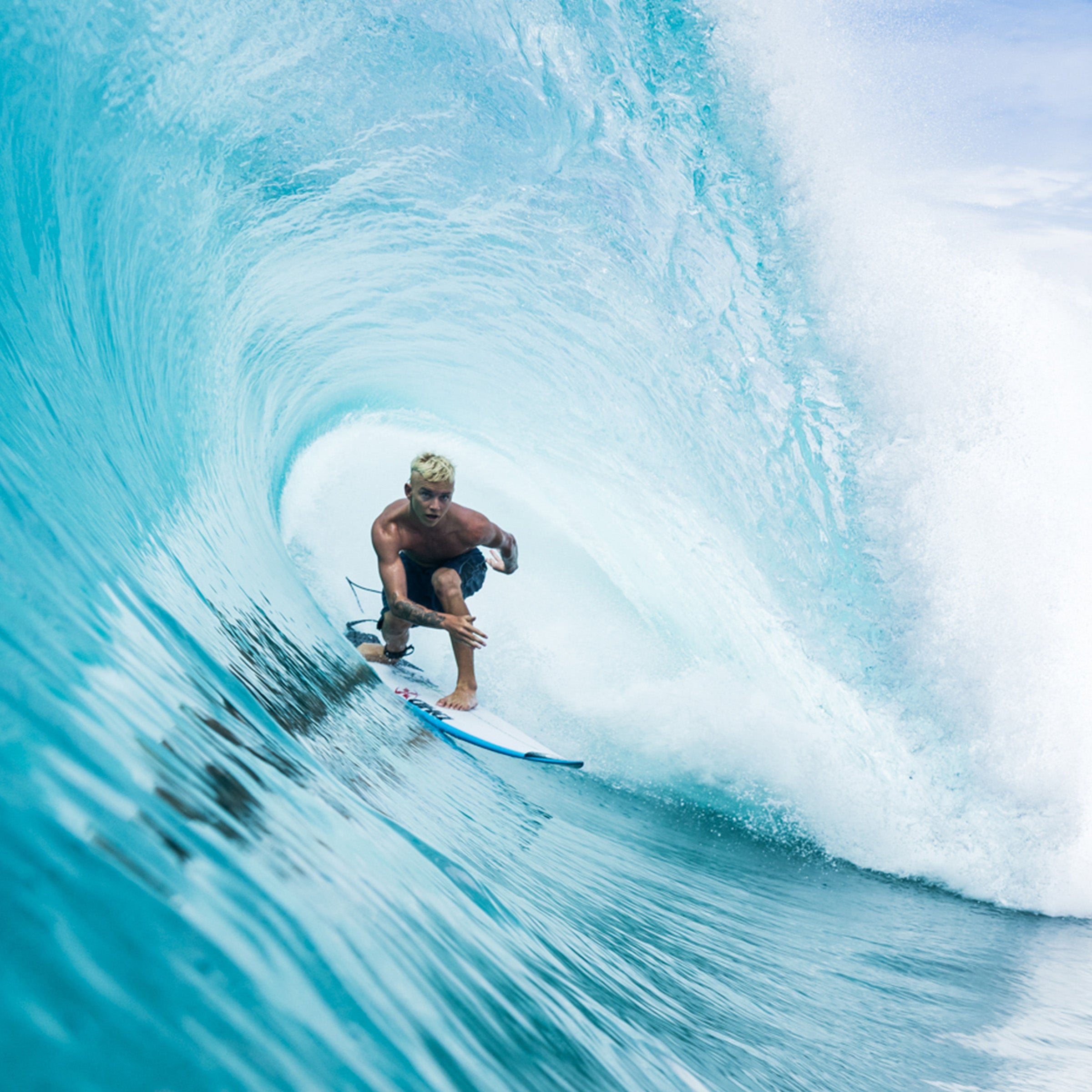 Person surfing inside a tube of a wave