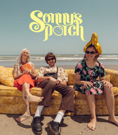 Three people sitting on a couch at the beach with 'Sonny's Porch' text above.
