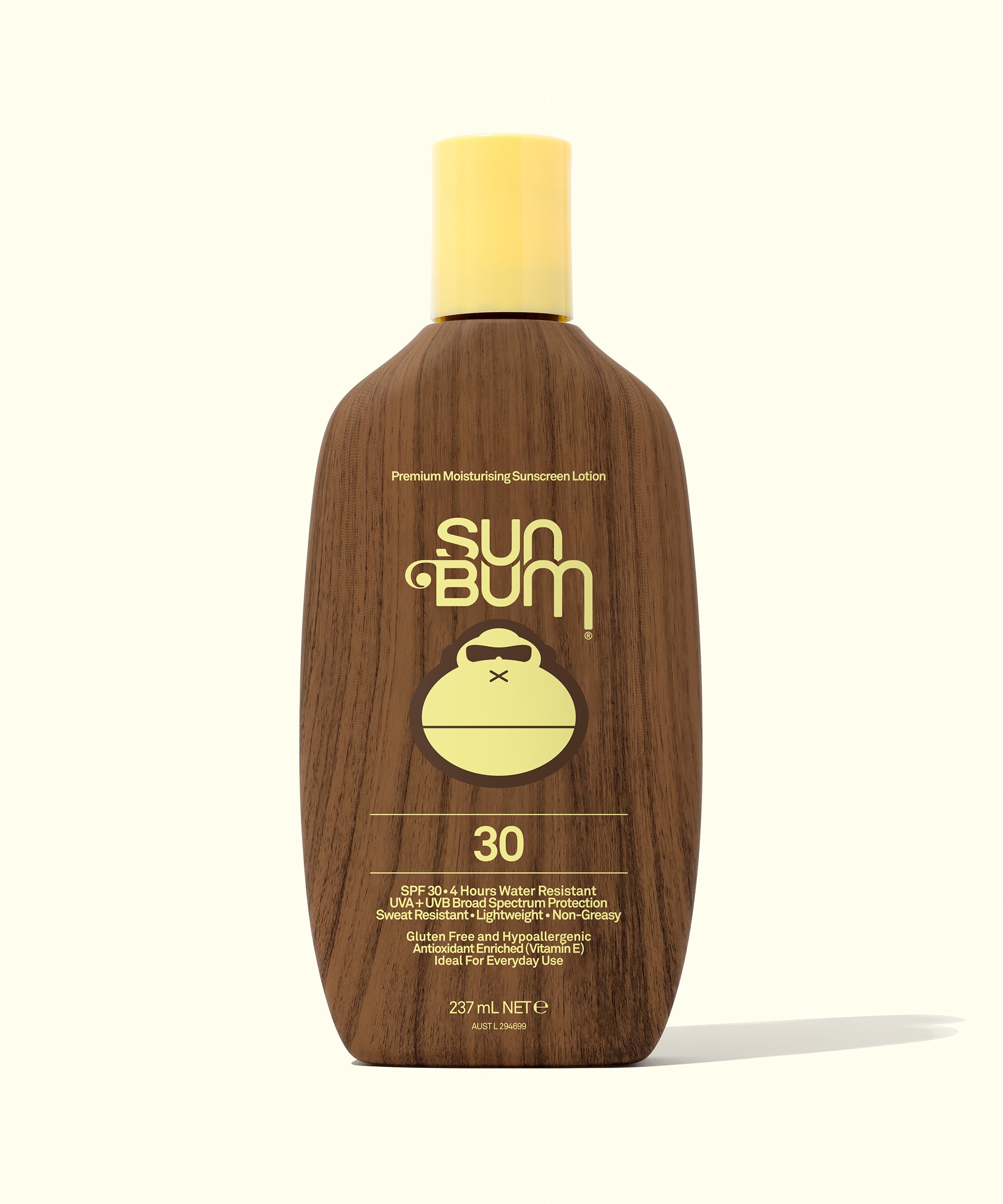 Sun Bum sunscreen lotion bottle with wooden texture on a white background