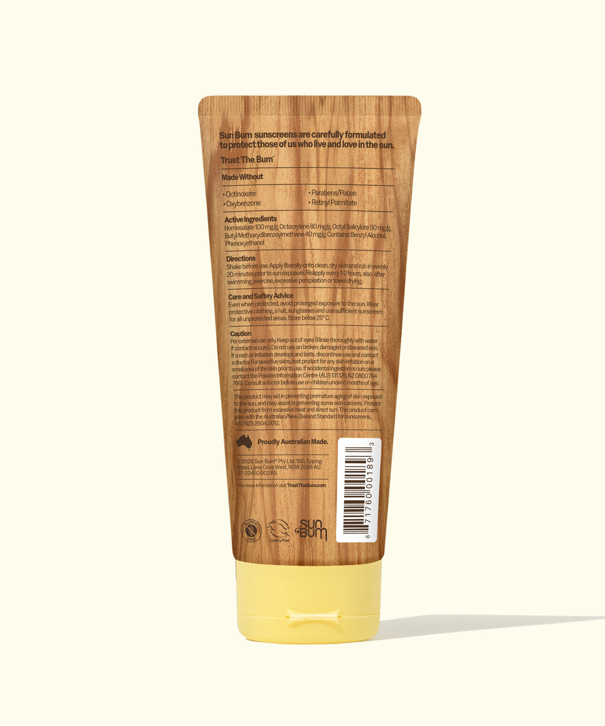 The back of a Trust The Bar sunscreen tube, featuring a brown wood-grain pattern and a pale yellow cap, on a light cream background.