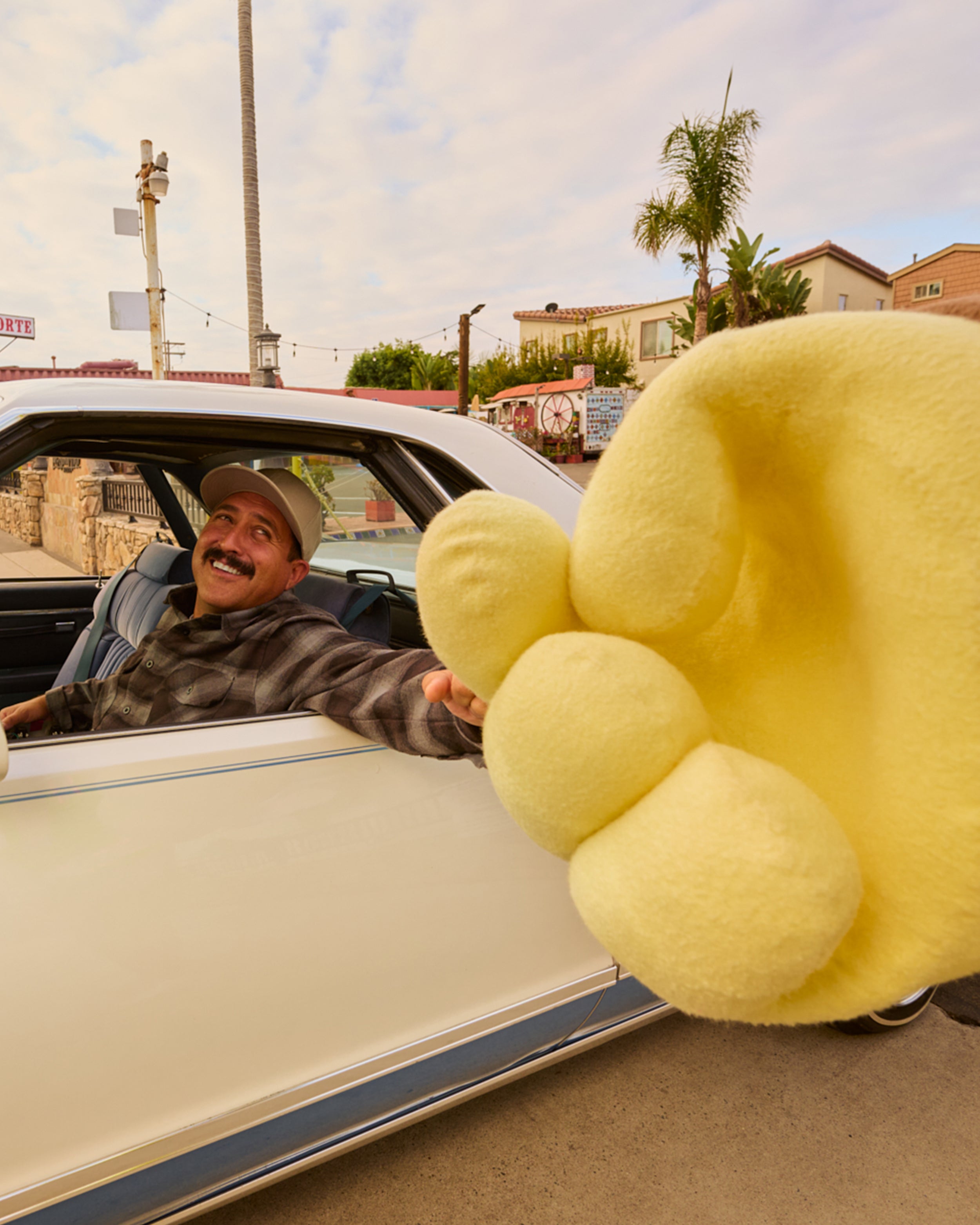 Sonny fist bumping a guy in a car.