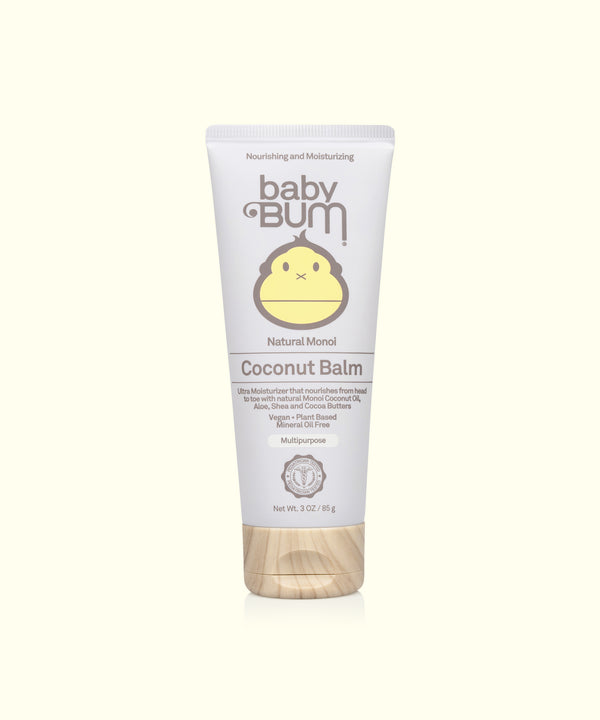 A tube of Baby Bum Natural Monoi Coconut Balm with a white body and a smiling sun logo at the top. The packaging indicates that the product is hypoallergenic and gluten-free.